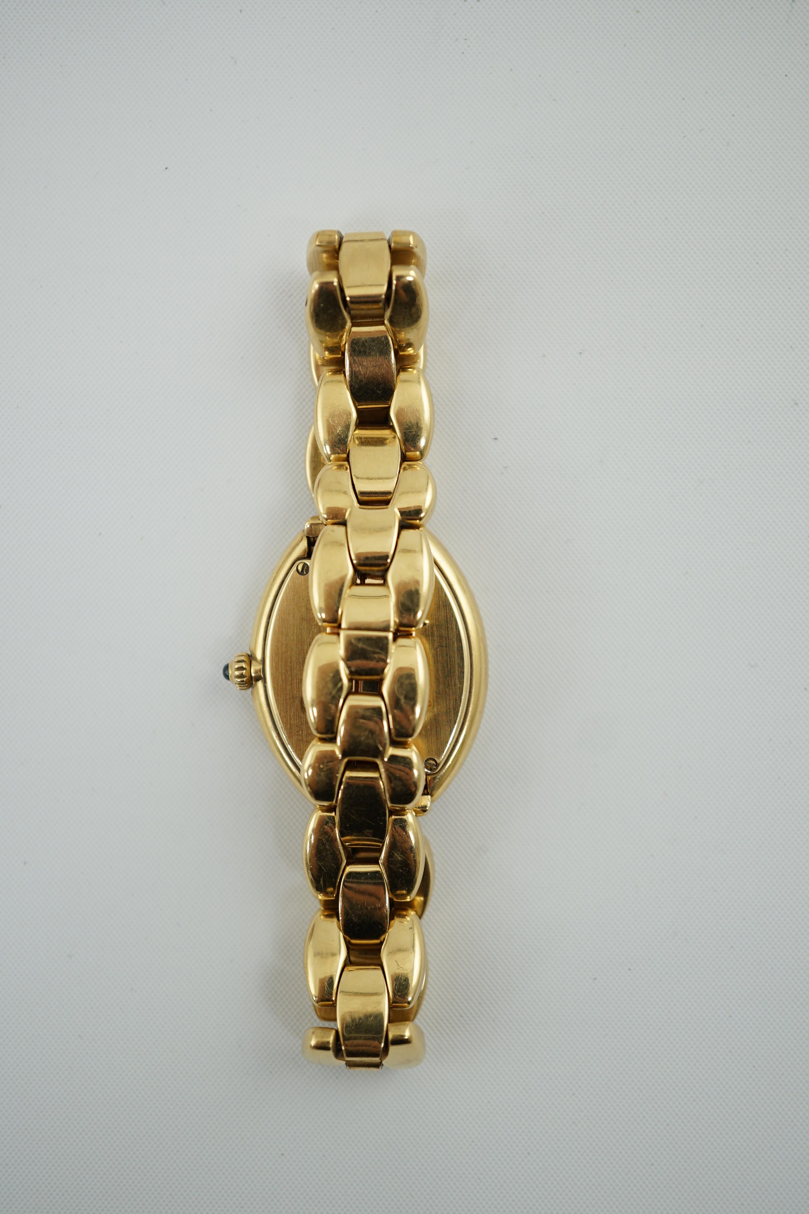 A lady's late 1990's? 18k gold Cartier quartz wrist watch, on an 18 k gold Cartier bracelet